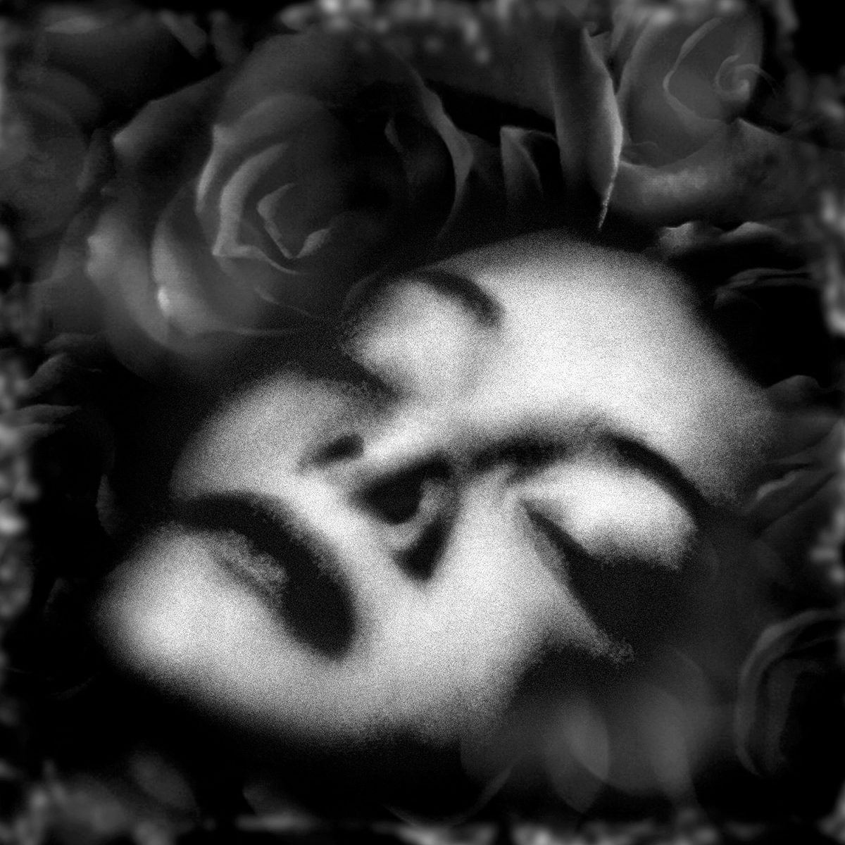 A black and white photo of a woman with her eyes closed.