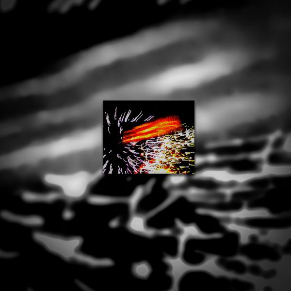 An American Flag blowing in the wind in front of fireworks in the sky.