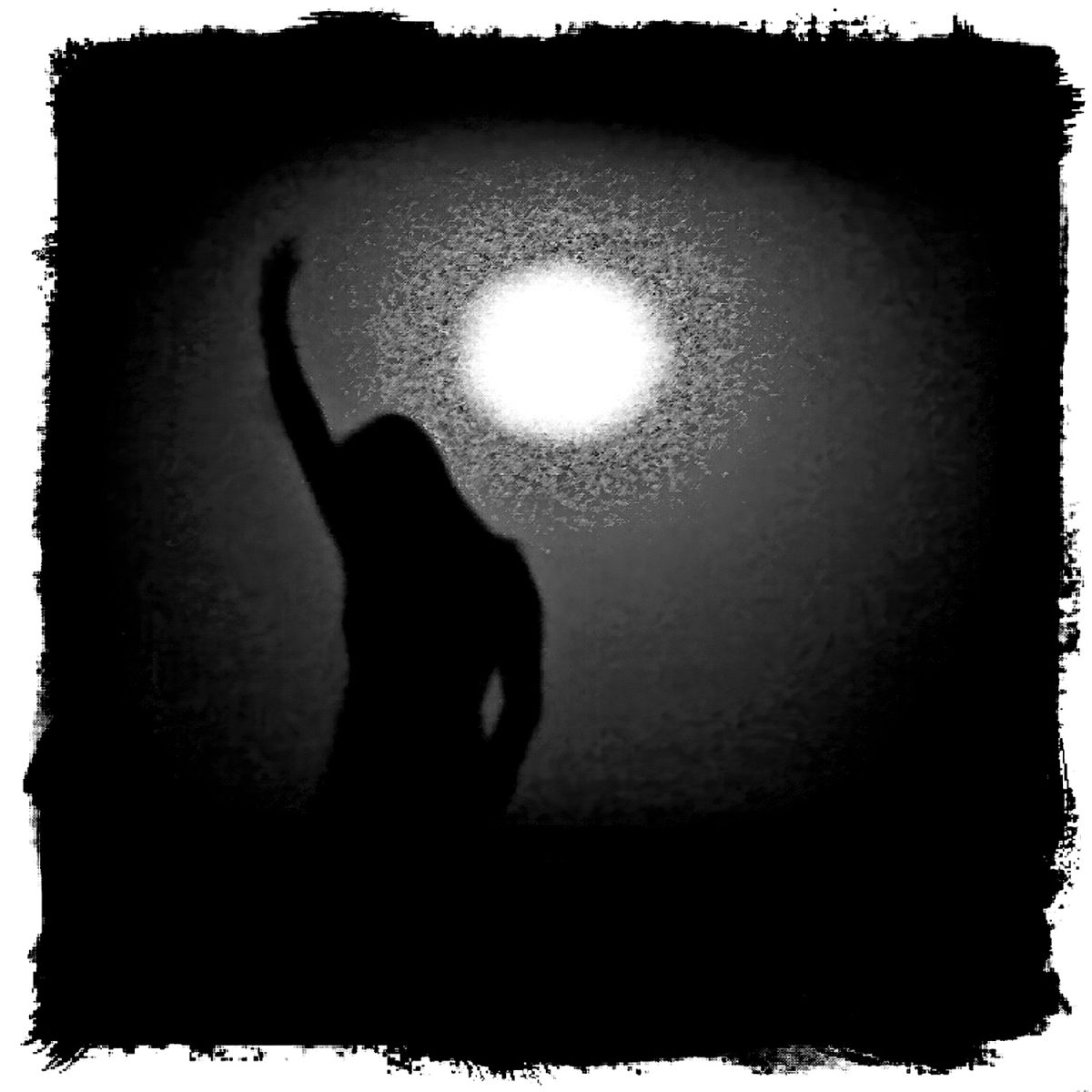 A silhouette of a woman holding up her hands in the dark.