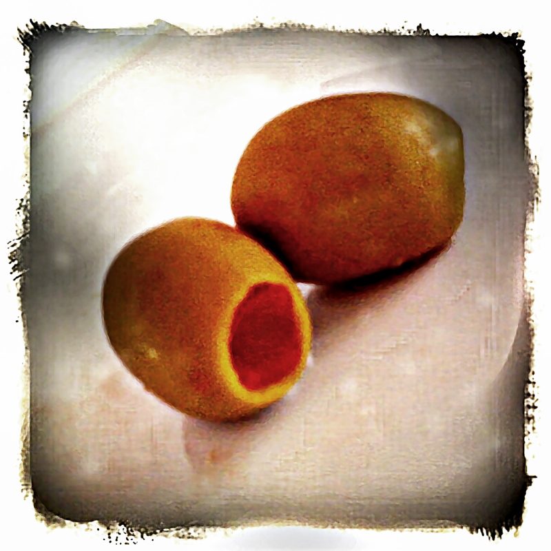 Two olives on a plate.