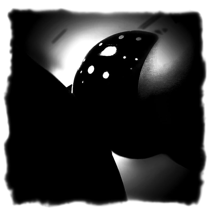 A black and white photo of a ball on a pool table.