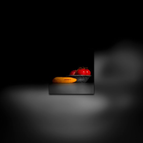A color photo of a bowl with a banana and tomatoes.