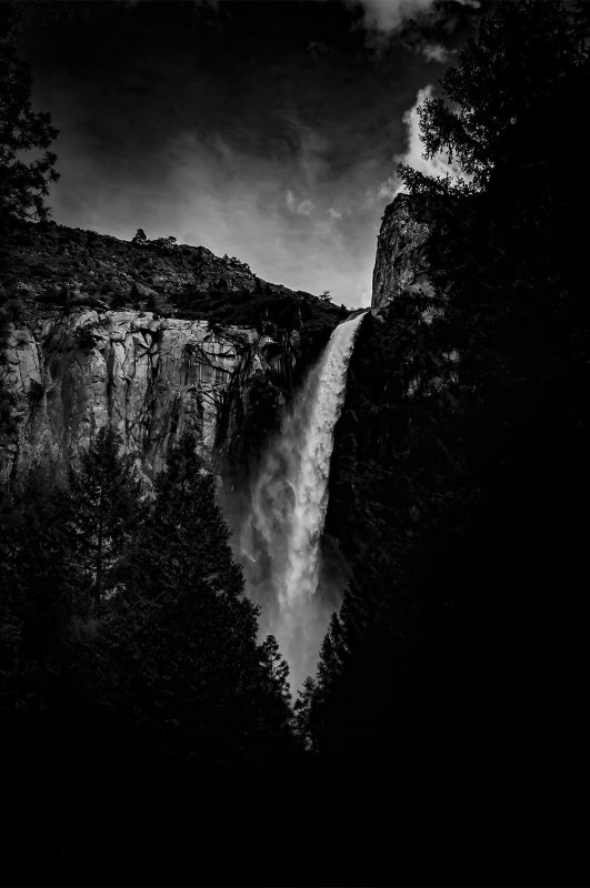 Dark scenic waterfall landscape in Yosemite National Park, black and white fine art photography.