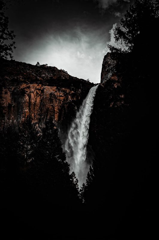 Waterfall landscape dark moody scenery at Yosemite National Park.