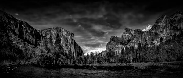 Majestic black and white landscape of Yosemite Valley with towering granite cliffs and river, showcasing Doug Heslep's fine art collection.