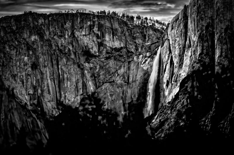 Aerial view of a Upper Yosemite Falls in Yosemite National Park, black and white photography, dramatic cliffs, rugged landscape, natural scenic beauty, The Doug Heslep Fine Art Collection.