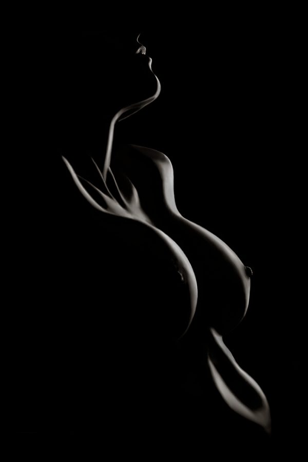 A woman's body is shown in the dark.