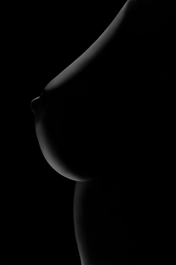 A black and white photo of a woman's breast.