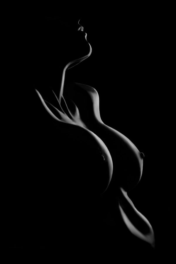 A woman's body is shown in the dark.