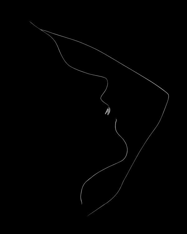 A black and white backlit outline of a woman's face.