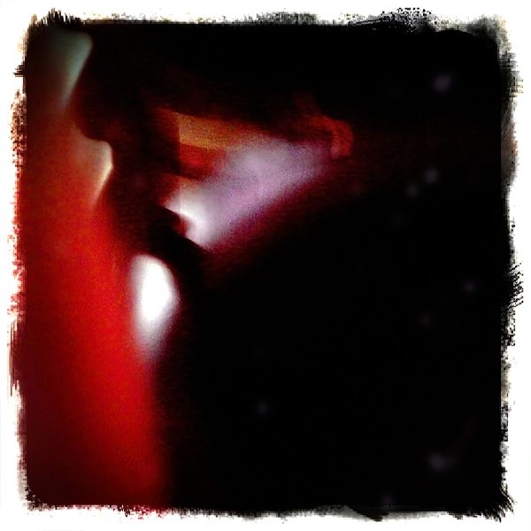 Abstract figure walking by in a blurred, colorful scene.