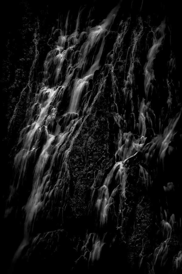 Dark waterfall black and white fine art photography, The Doug Heslep Fine Art Collection, exhibiting fluid motion and contrast.