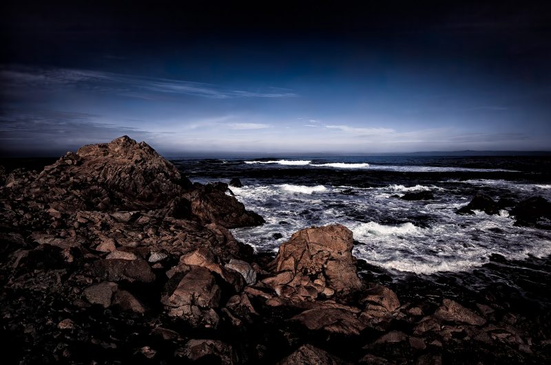 Wild rocky ocean shoreline under stormy sky | The Doug Heslep Fine Art Collection