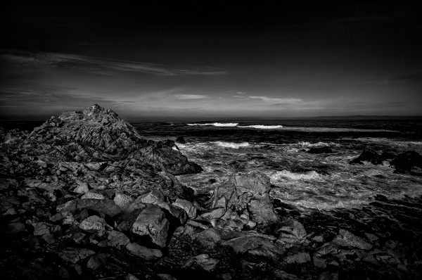 Clouds over rocky shoreline in black and white, dramatic ocean scene, The Doug Heslep Fine Art Collection, stunning monochrome landscape artwork, seascape photography.