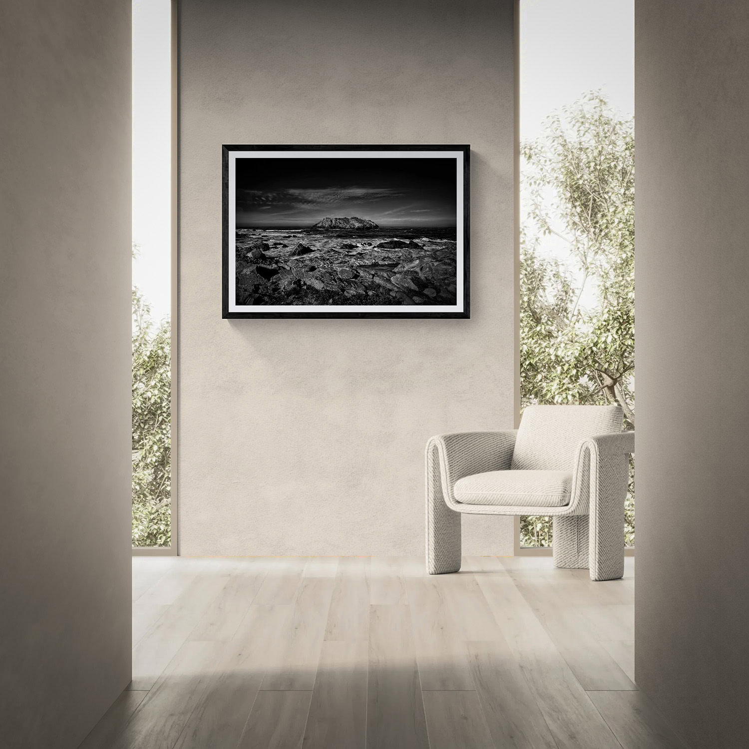 Black and white landscape photograph in a modern gallery setting.