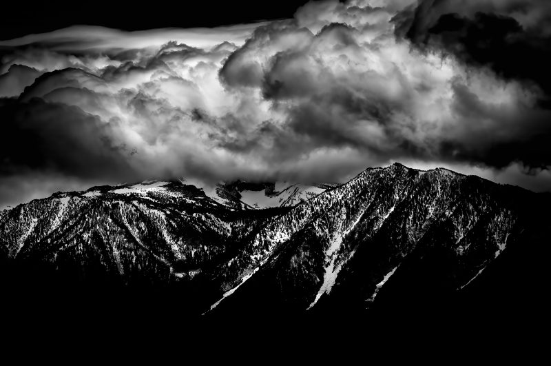 Majestic black and white mountain landscape with dramatic cloud formation, part of The Doug Heslep Fine Art Collection.