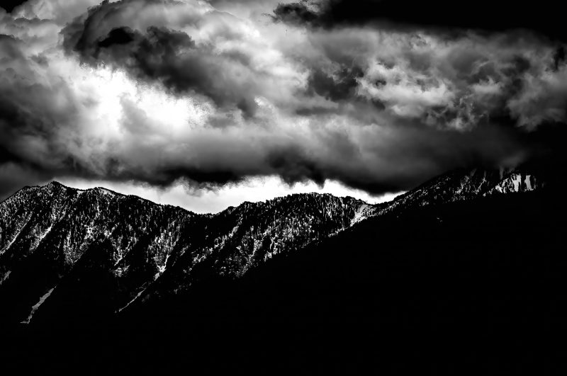 Mysterious black and white mountain landscape with dramatic cloudy sky, fine art photography by Doug Heslep.