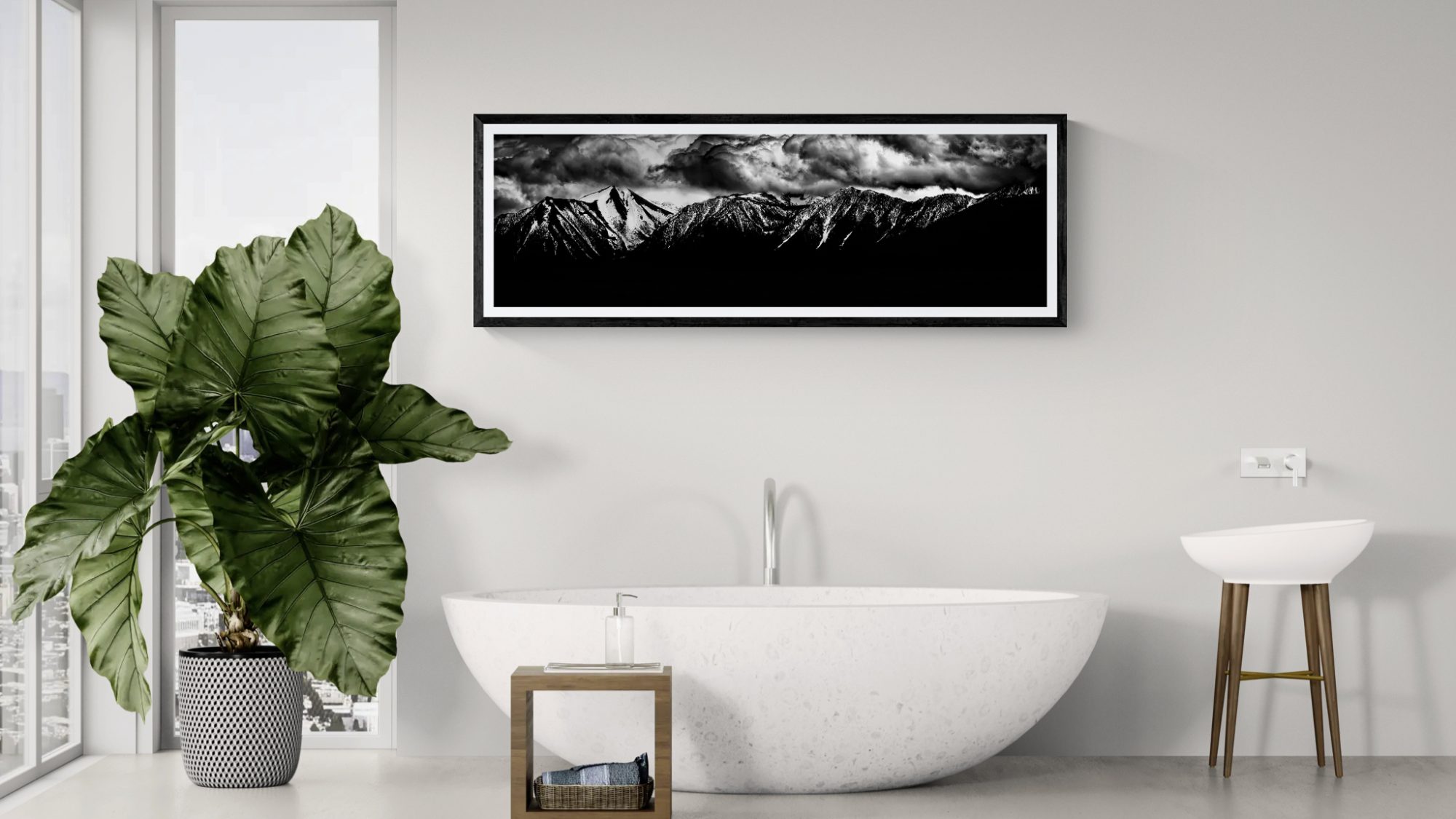 Mountain landscape painting in black and white, displayed above a modern bathtub.