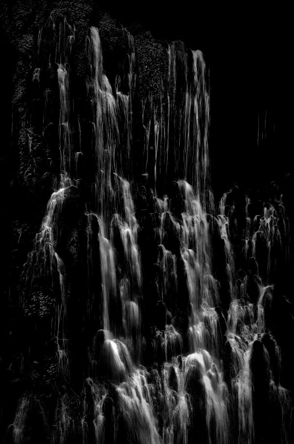 A close-up shot of Burney Falls in black and white.