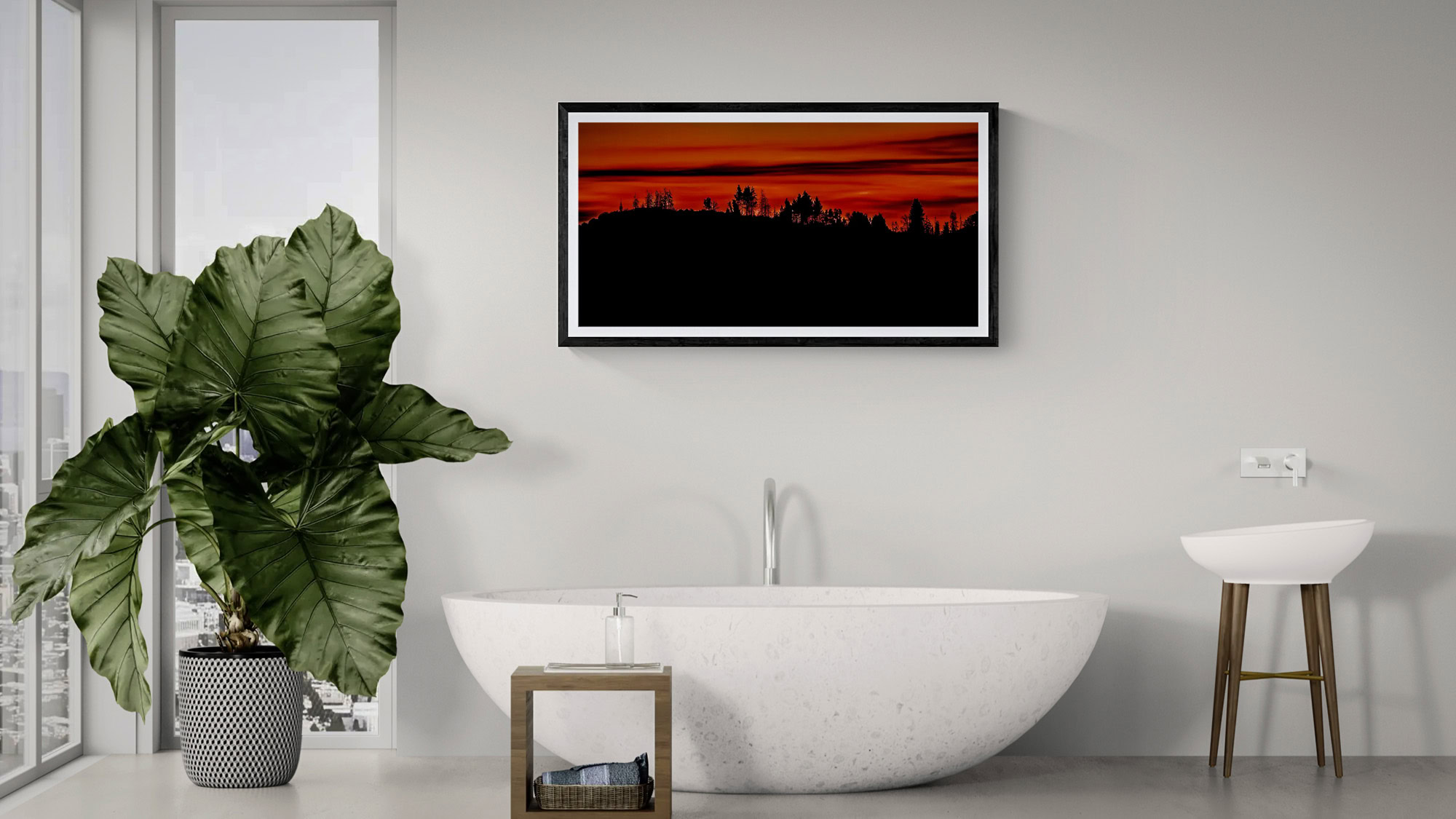 Sunset landscape artwork above a modern freestanding bathtub in a sleek, minimalist bathroom setting.