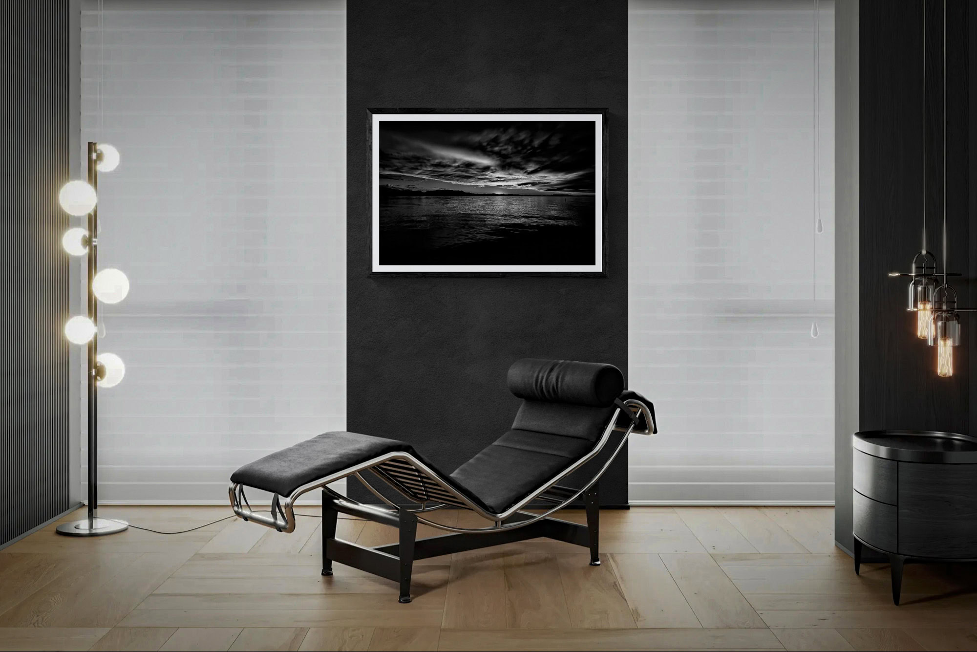 Contemporary living room with black lounge chair and framed landscape art.