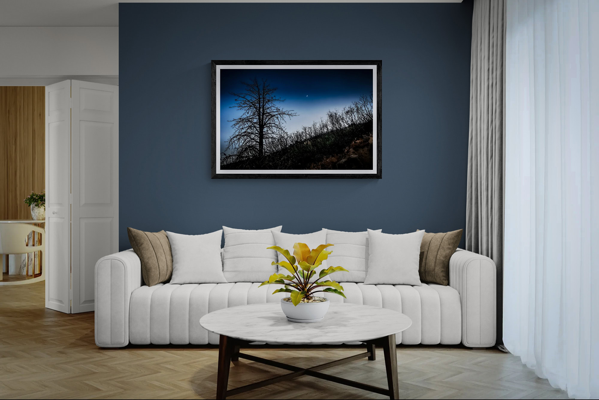 Night sky landscape with trees and stars, framed wall art in modern living room.