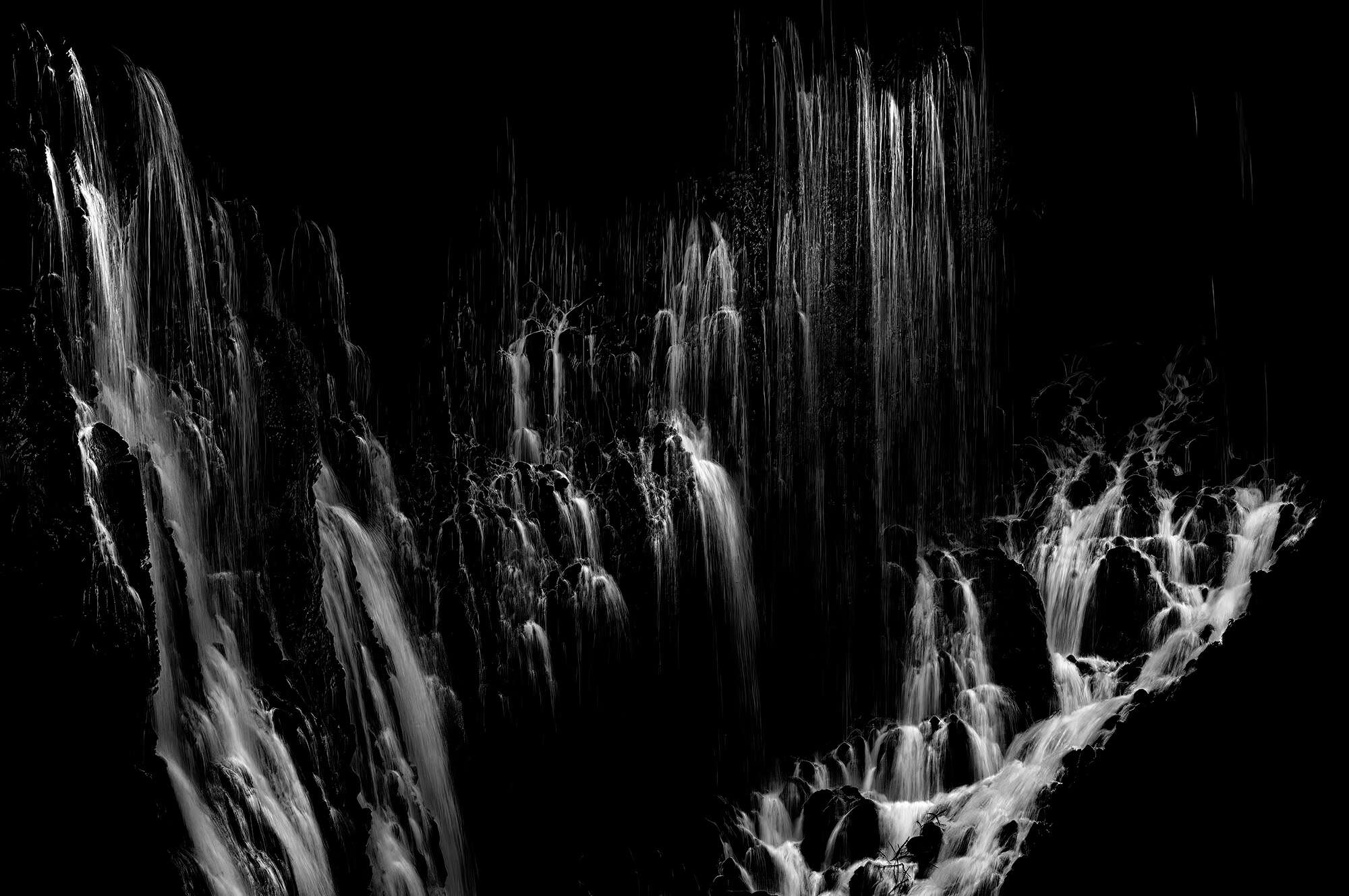 A black and white close up photograph of Burney Falls