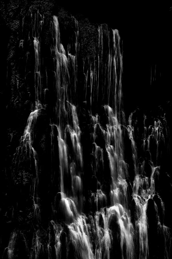 A black and white close up photograph of Burney Falls