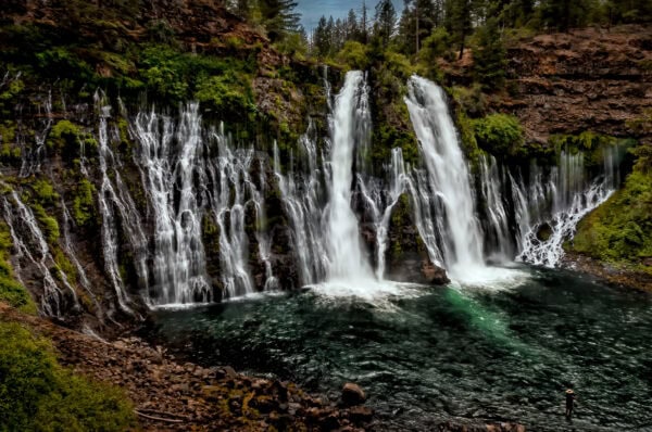 A fisherman with Burney Falls