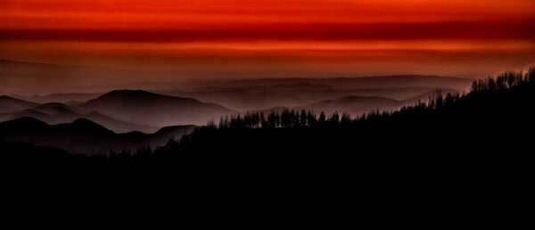 Colorful sunset while looking west across the mountain range after exiting King's Canyon