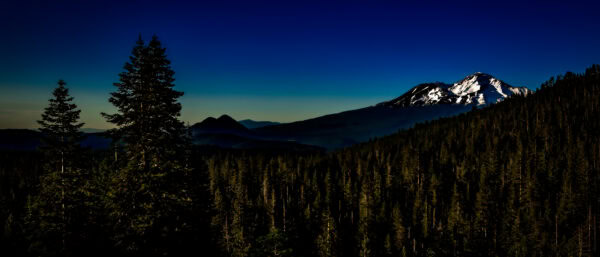 An evening view of Mount Shasta and Black Butte as seen from Castle Lake