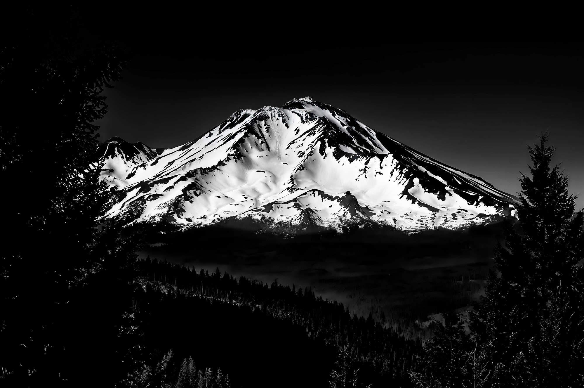 A black and white photo of snow covered Mount Shasta
