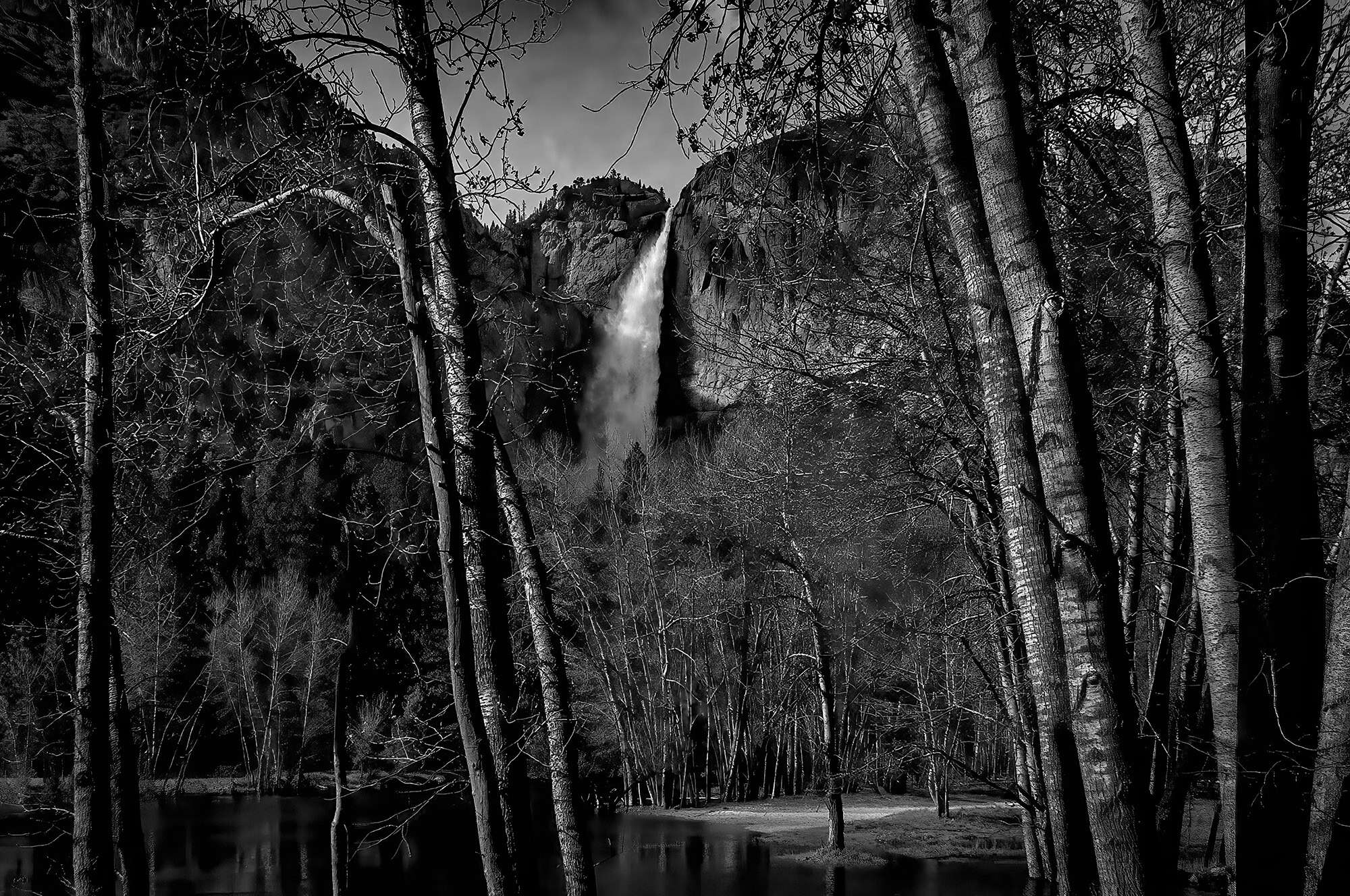 Upper Yosemite Falls framed thru trees.