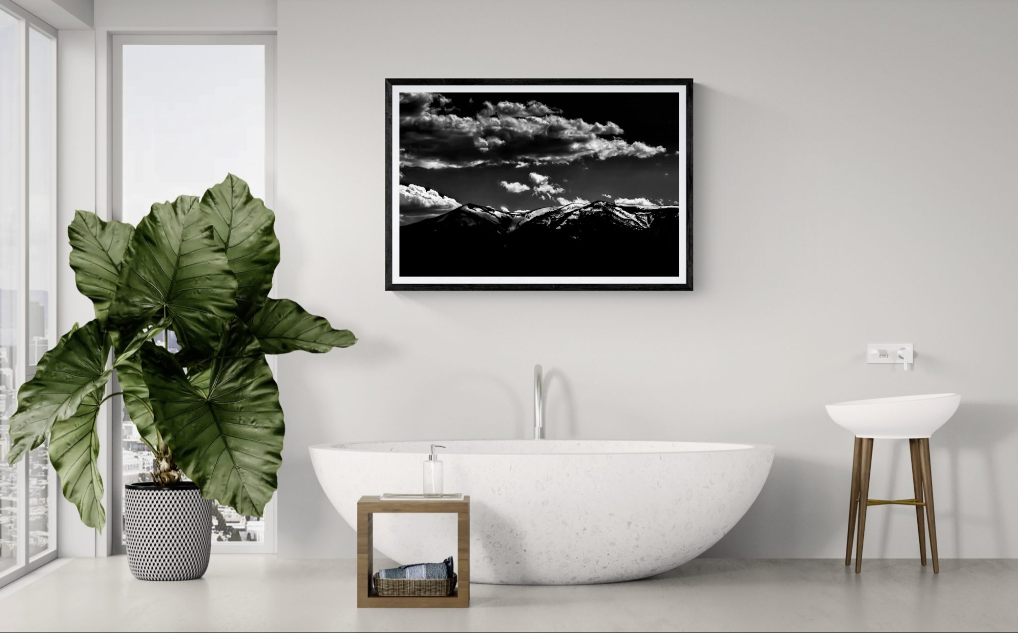 Black and white mountain landscape art by Doug Heslep in a contemporary bathroom with a freestanding.