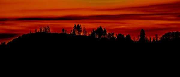 Colorful sunset while looking west across the mountain range after exiting King's Canyon