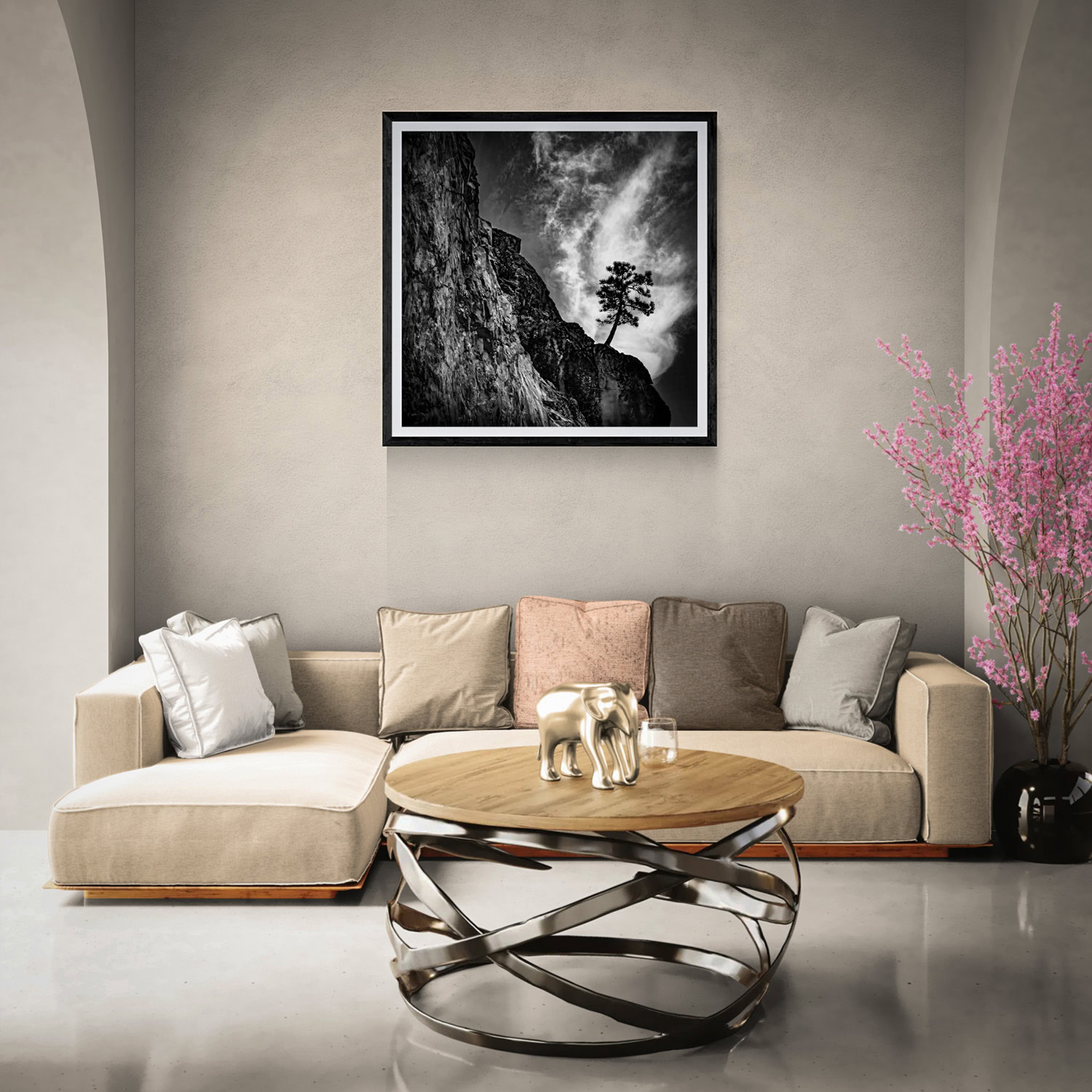 Contemporary living room featuring artwork, neutral sofa, and pink flowering tree in a black vase.