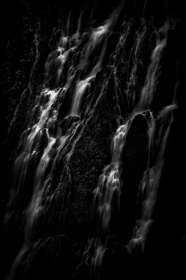 A close-up shot of Burney Falls in black and white.