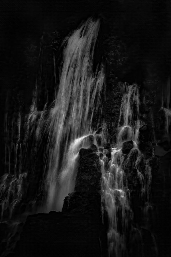 A close-up shot of Burney Falls in black and white.