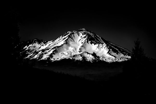 A snow covered Mount Shasta with a clear sky