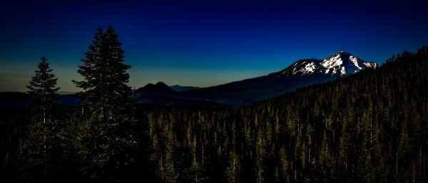 An evening view of Mount Shasta and Black Butte as seen from Castle Lake