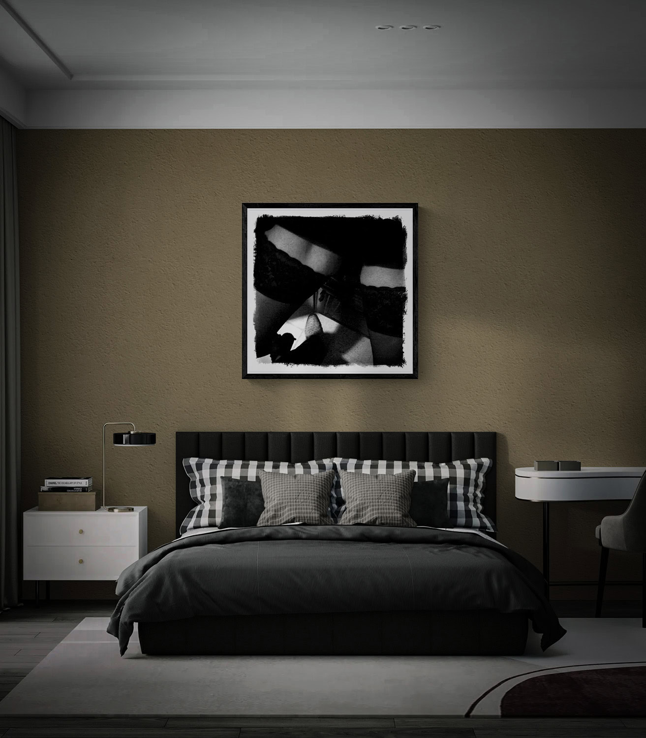“Nice Boot” black-and-white fine art photograph in a black frame above a bed, with dark bedding and a textured taupe wall.