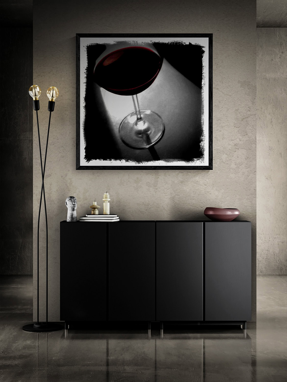 “Red Red Wine,” a mostly monochrome photograph of a glass of red wine, framed above a black sideboard beside a slender floor lamp.