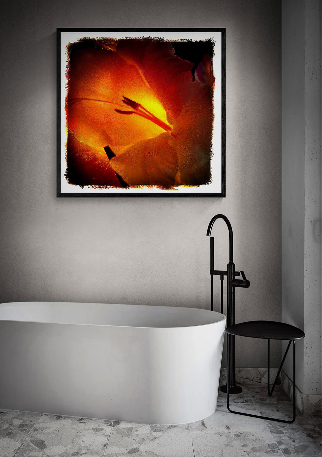 “The Glow Within,” a glowing orange and yellow flower close-up, displayed in a black frame above a white freestanding bathtub.