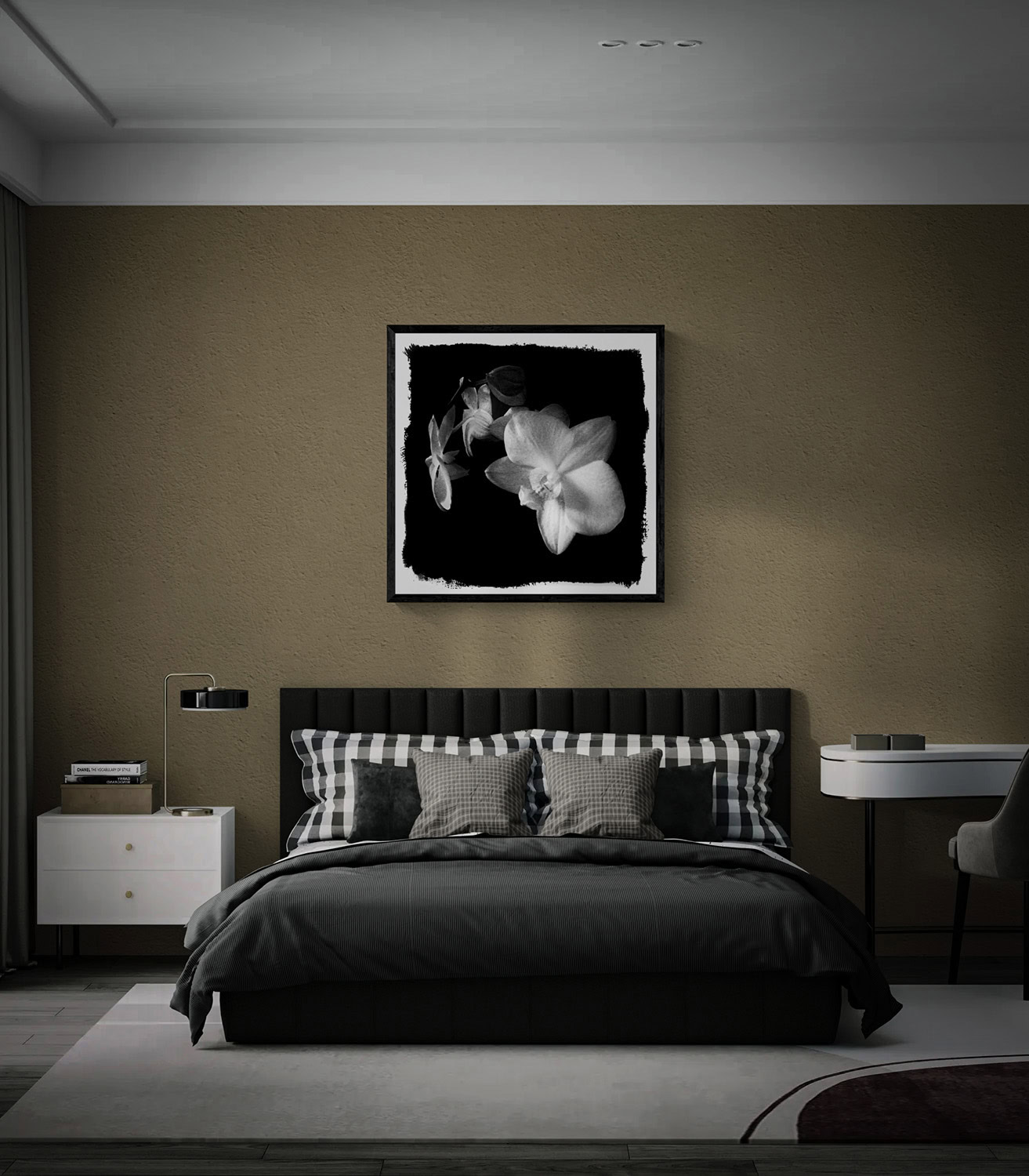 “Poise,” a black-and-white photograph of orchid blossoms against black, framed above a bed against a textured taupe wall.